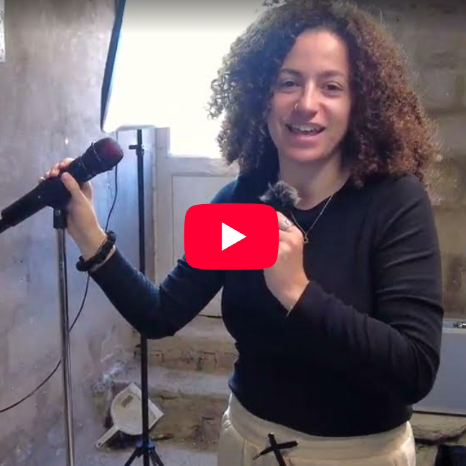 A YouTube video thumbnail titled 'Pre Tour Rig Rundown' by Mallavora, showing a woman holding two microphones in front of a concrete wall with audio equipment. The thumbnail includes a red YouTube play button overlay and the text 'Watch on YouTube' at the bottom.